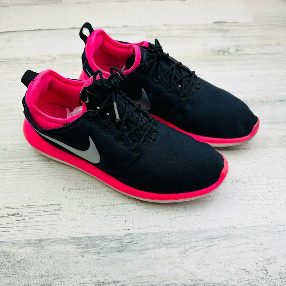 Black and hot pink Nike running shoe